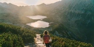 Woman walking near the lake in Tatra mountains Woman walking near the lake in Tatra mountains