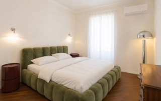 La camera da letto è focalizzata sul comfort del letto Lupine di Micadoni, affiancato dai comodini Ross di Northdeco. Un attento studio dell'illuminazione calibra atmosfera e funzionalità: da un lato l'iconica applique E’ di Kartell diffonde luce puntuale, dall'altro la lampada da terra Walter della Westwing Collection crea un'allure speciale. A vestire l'ambiente con eleganza sartoriale sono i tendaggi su misura di DMG Arredo Design. La camera da letto è focalizzata sul comfort del letto Lupine di Micadoni, affiancato dai comodini Ross di Northdeco. Un attento studio dell'illuminazione calibra atmosfera e funzionalità: da un lato l'iconica applique E’ di Kartell diffonde luce puntuale, dall'altro la lampada da terra Walter della Westwing Collection crea un'allure speciale. A vestire l'ambiente con eleganza sartoriale sono i tendaggi su misura di DMG Arredo Design.