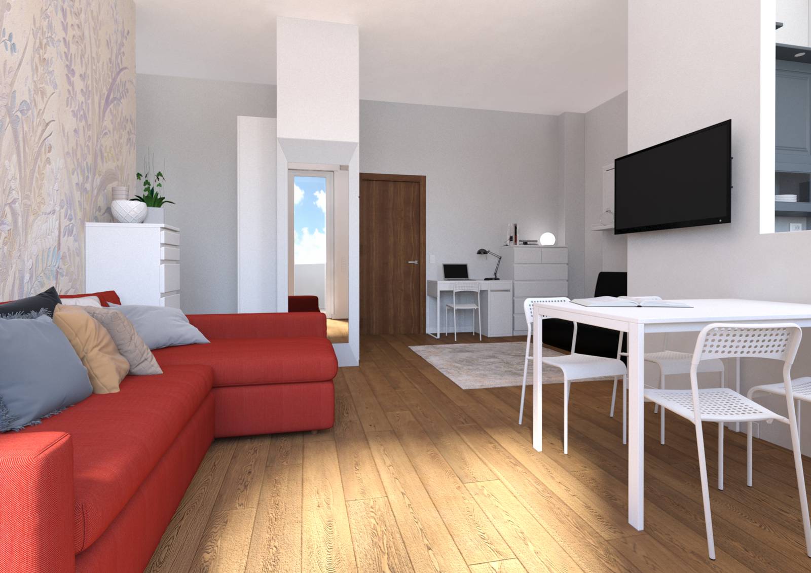 Nell'open space con cucina aperta e solo parzialmente definita da un muretto, a parete dietro il divano è decorata con una tappezzeria floreale che mixa toni rosa, glicine e grigio (presente nella zona cottura e sulle pareti di ingresso e zona studio).